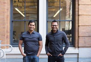 Harness co founders standing in front of brick building